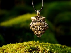 Viking mask amulet in nature