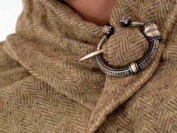Viking Age ring brooch in use