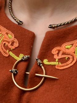 Viking wolf head ring brooch in use